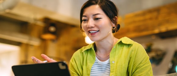 young woman talking with someone on her laptop