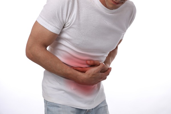 person in a white tshirt holding for his belly