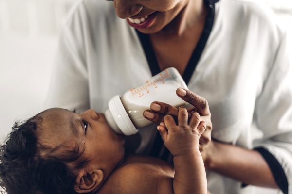 African American mom feeding a bottle to her baby